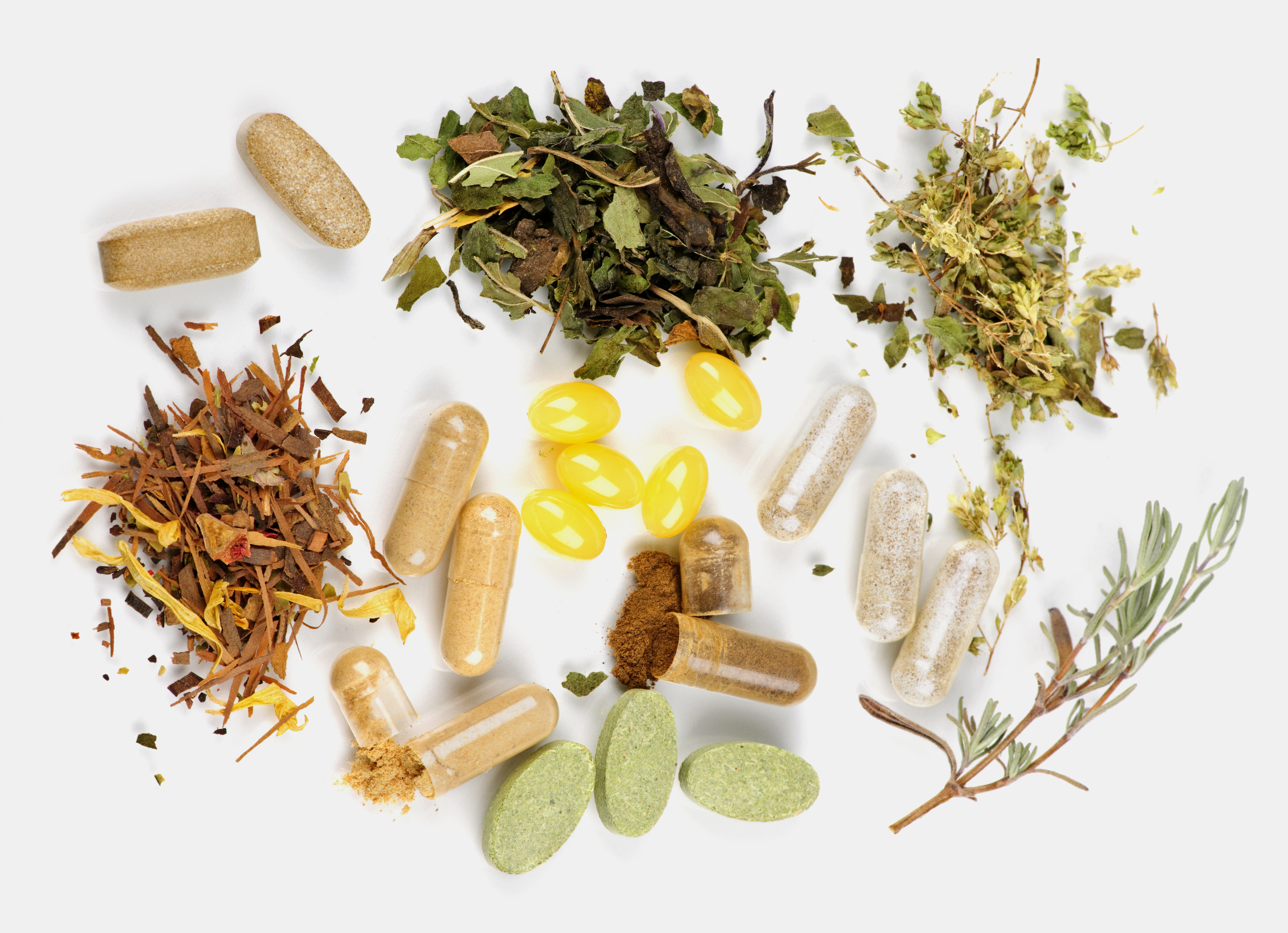 Herbal medicine: dried herbs and natural supplement capsules